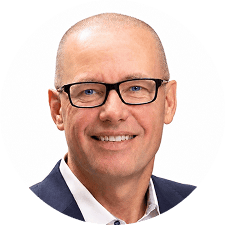 Smiling middle-aged man with glasses, short hair, and wearing a suit jacket with a white shirt, shown against a plain white background—representing executive and physician leaders from the Radiology Partners Board of Directors.